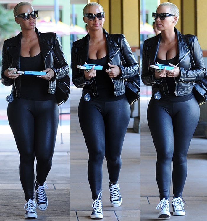 Amber Rose nails the off-duty formula in Studio City, pairing a low-cut tank top and curve-hugging leggings with a biker-chic leather jacket and classic Converse high-tops