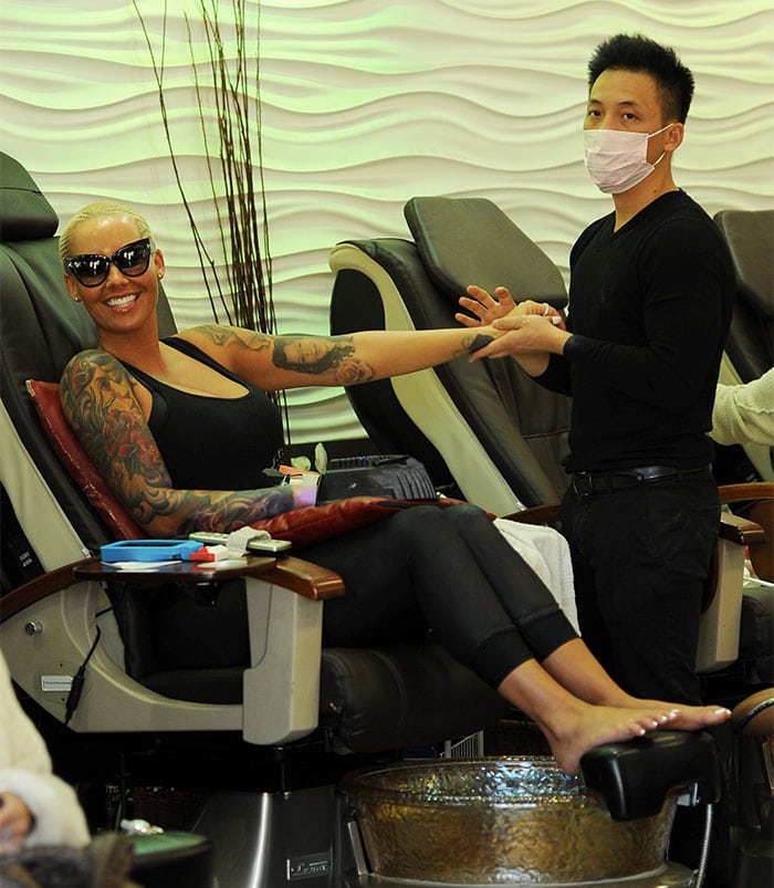 Amber Rose flashes a big smile while getting a manicure at Nail Garden, showing off her tattooed arms and laidback leggings look