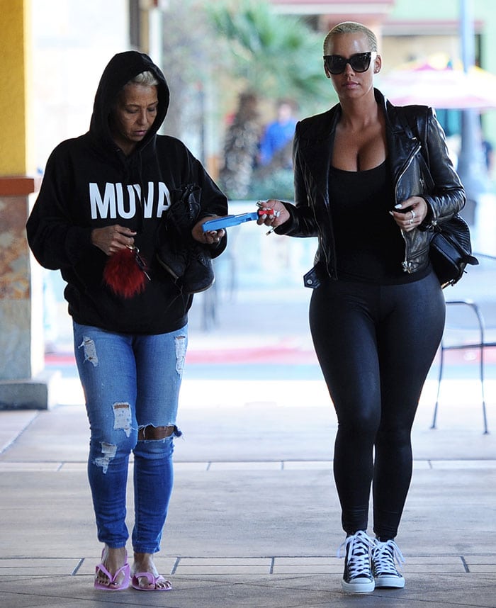 Amber Rose steps out in Studio City with her mom, Dorothy, pairing sleek black leggings and a leather jacket with classic Converse high-tops for a casual manicure-and-grocery run