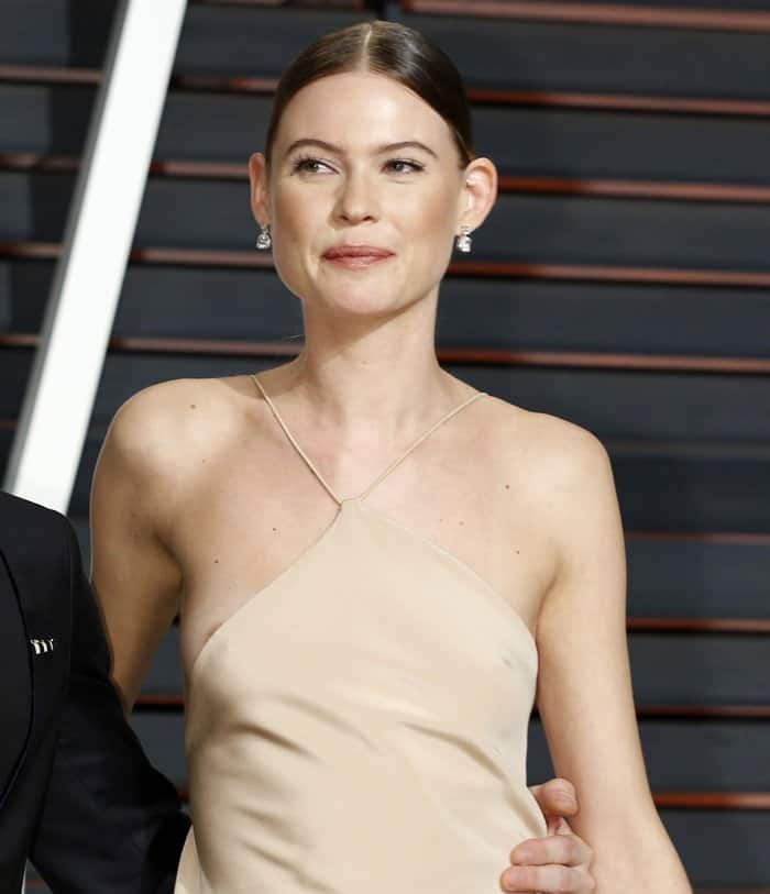 Behati Prinsloo was busy smiling at the photographers when she noticed something amiss