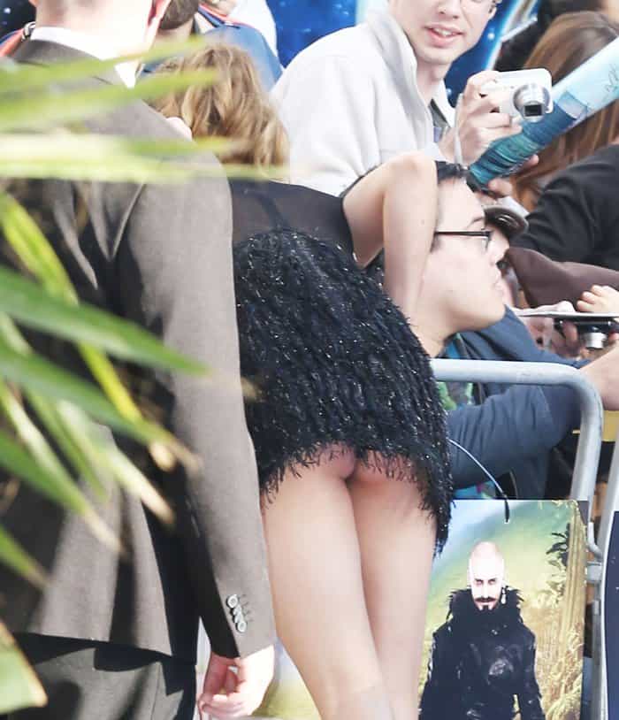 Cara Delevingne gave fans a little more than an autograph when she bent over in her feathered mini dress—proving that even supermodels aren't immune to red carpet slip-ups
