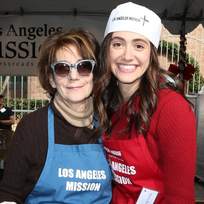 Emmy Rossum and her mother, Cheryl Rossum, volunteer together at the Los Angeles Mission on Christmas Eve 2015, coordinating festive red-and-blue aprons during the annual holiday outreach event