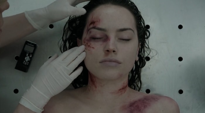 Daisy Ridley's character, Hannah Kennedy, is examined during a forensic investigation scene in Silent Witness