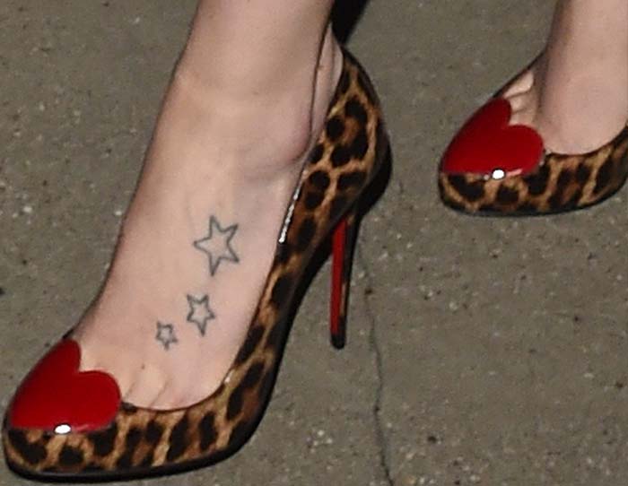 Daisy Ridley's feet in Christian Louboutin heart-and-leopard-print pumps, revealing her first tattoo—three outlined stars on her left foot, which she got at age 15