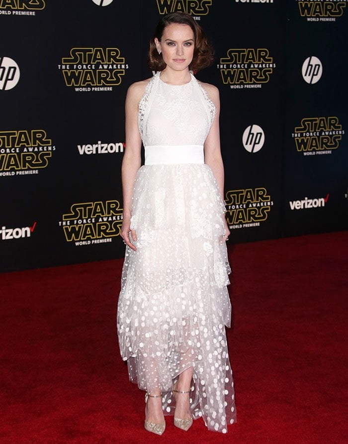 Daisy Ridley's halter dress features a cinched waist, a tiered polka dot tulle skirt, and a Chantilly lace bodice