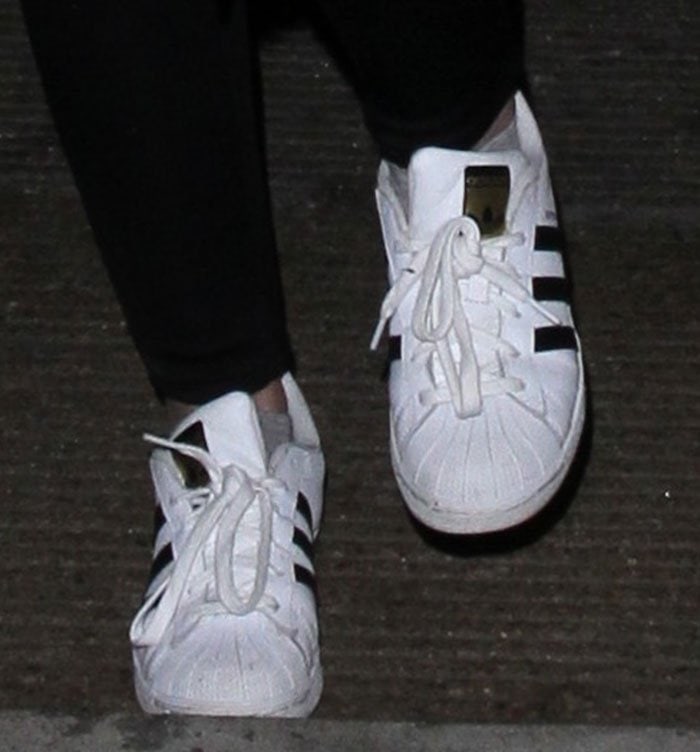 Her well-worn adidas Superstars showcase the style’s iconic shell toe and three-stripe design
