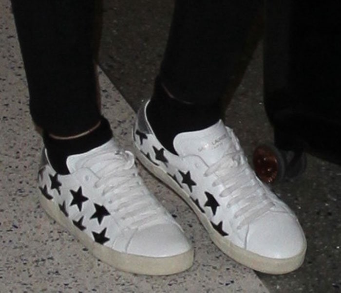 Ellie Goulding steps out in Saint Laurent’s white Court Classic SL/06 sneakers, featuring bold black star appliqués and a vintage-inspired rubber sole for effortless off-duty polish