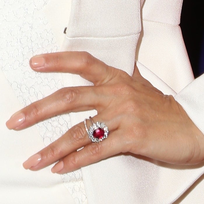A halo of diamonds surrounds Eva Longoria's stunning ruby engagement ring, elegantly set on a white gold band