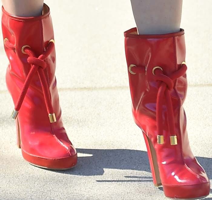 Glossy red patent Dsquared2 ankle boots brought a bold pop of color to the ensemble, reflecting the fearless shoe choices that have long defined Stefani's personal style