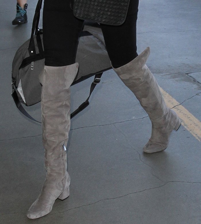 Kate Upton effortlessly elevates her airport style in chic gray suede Sam Edelman thigh-high boots
