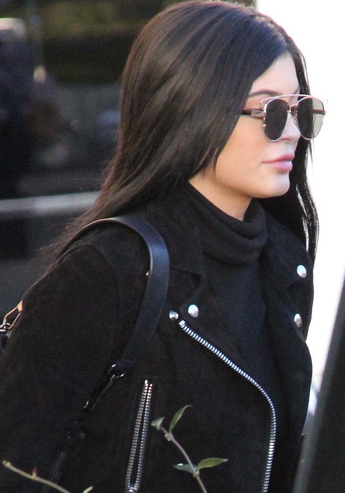 Kylie kept it sleek in an all-black Acne Studios biker jacket layered over a cropped turtleneck