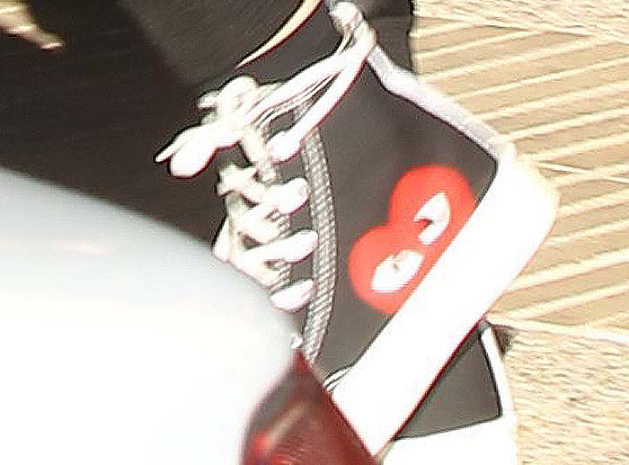 A close-up reveals the playful red heart motif from the Comme des Garçons x Converse collaboration