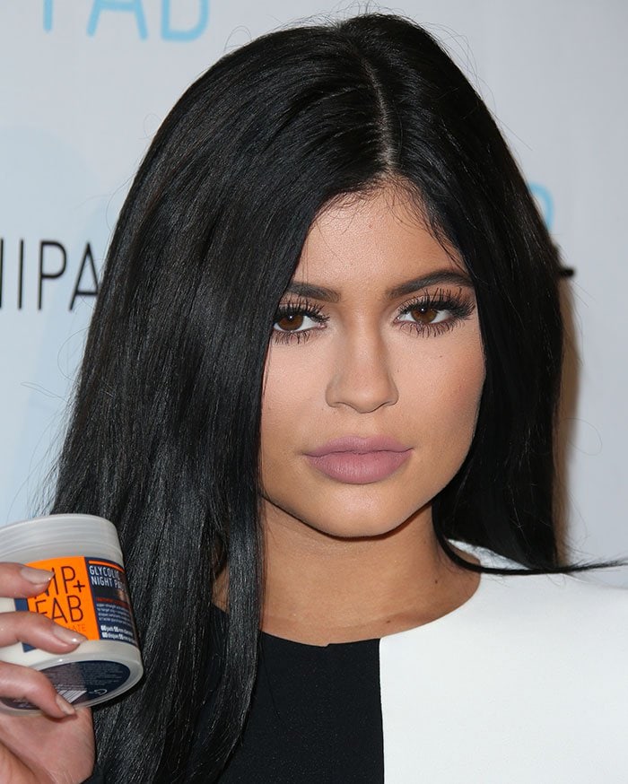 Kylie Jenner showcases her signature matte nude lips and bold lashes while promoting Nip + Fab skincare