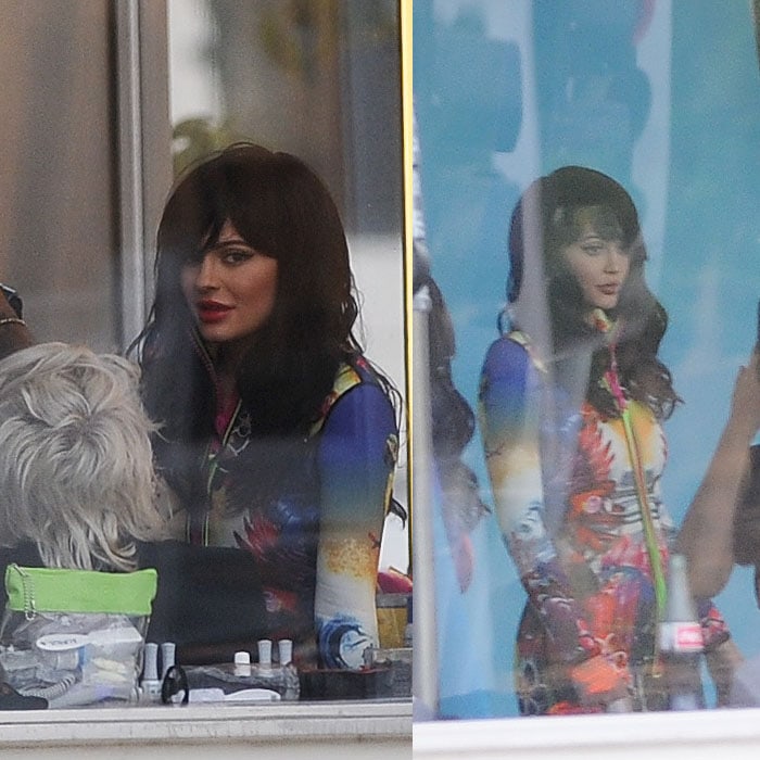 Peeking out from her photoshoot set, Kylie Jenner notices the paparazzi lenses snooping in on her