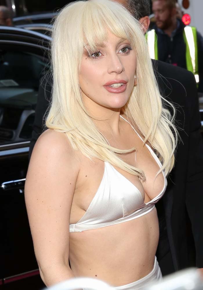 Lady Gaga arrives at the 2015 Billboard Women in Music Awards in New York City wearing a minimalist ivory two-piece ensemble that highlighted her stripped-back, avant-garde aesthetic