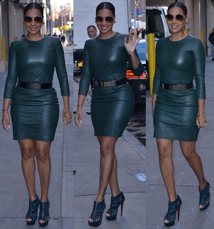 La La Anthony turns heads in a fitted green leather dress and sky-high teal Louboutins as she makes her way into AOL Build
