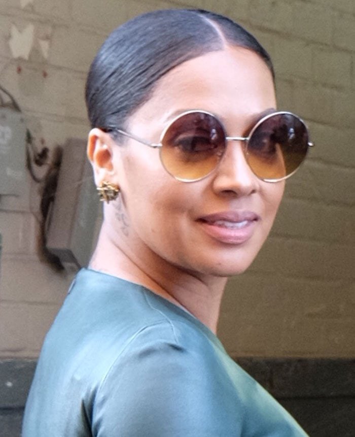 La La Anthony steps out in oversized round sunglasses and a sleek, center-parted bun while arriving at AOL Build in New York City