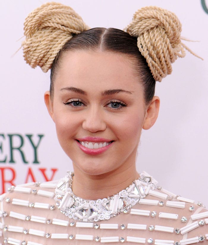 Miley Cyrus wears her hair in rope braid buns at the premiere of "A Very Murray Christmas"