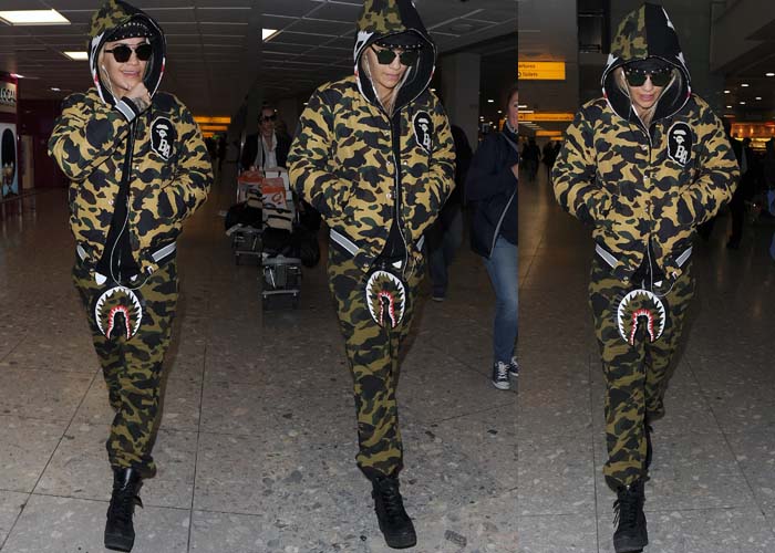 Rita Ora arrives at the airport in a head-to-toe A Bathing Ape camouflage tracksuit, grounding the bold streetwear look with chunky black platform boots