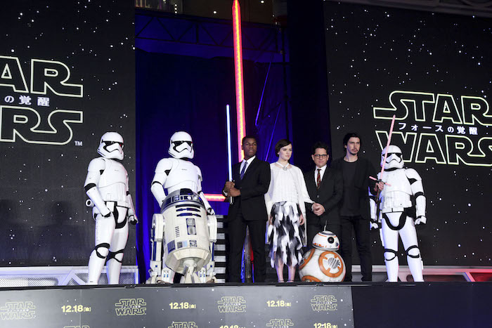 The cast of "Star Wars: The Force Awakens" bring out their lightsabers for a fan event in Japan