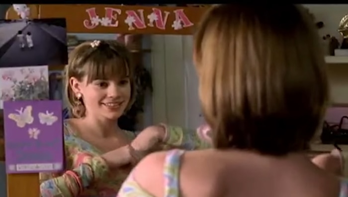 Christa B. Allen as young Jenna Rink smiles at herself in the mirror in 13 Going on 30