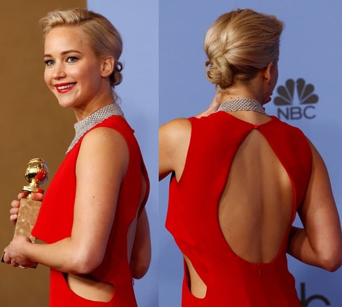 Jennifer Lawrence radiates with joy as she holds her Golden Globe, showcasing the stunning backless design of her red Dior Couture gown
