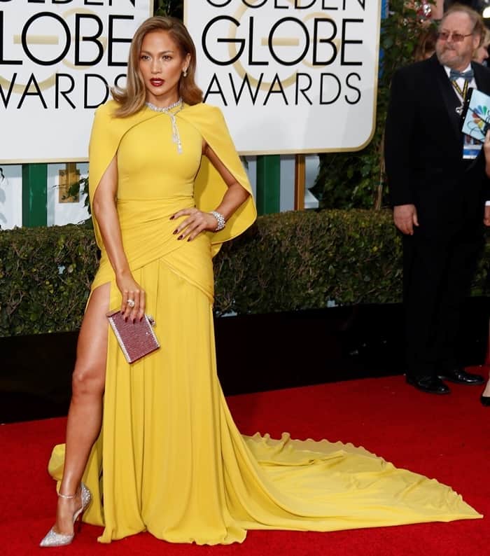 Jennifer Lopez commands attention in a vibrant chartreuse Giambattista Valli Haute Couture gown, complete with a dramatic cape and thigh-high slit, at the 2016 Golden Globe Awards