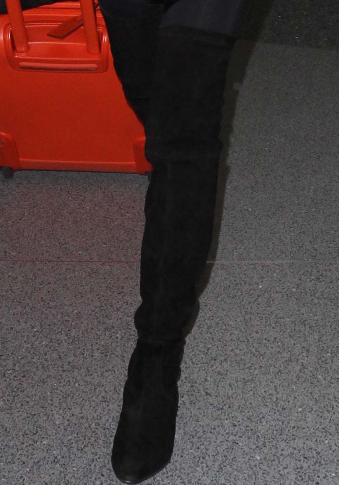 Bella Hadid steps out in Stuart Weitzman’s signature Lowland over-the-knee boots, showing off the sleek, stretch-suede silhouette that defines her go-to airport style