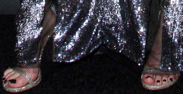 Bella Thorne flashes black-painted toes in glittering Stuart Weitzman sandals paired with a shimmering sequined outfit