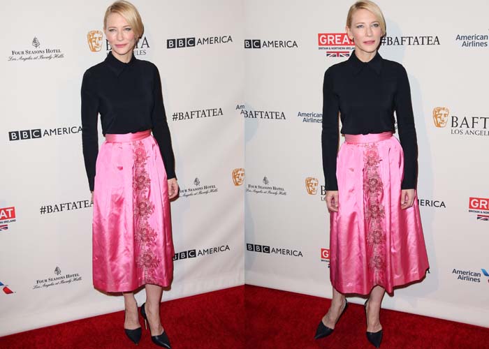 Her full-length look reveals a sharp contrast between the structured black top and the floral-embroidered satin skirt for a modern, feminine balance