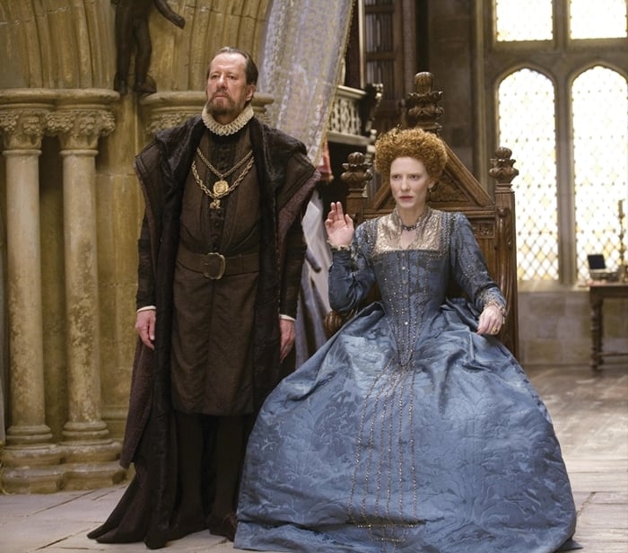 Cate Blanchett portrays the much shorter Queen Elizabeth I of England in Elizabeth and its sequel Elizabeth: The Golden Age, transforming her 5′8¼″ frame into the famously petite monarch through regal posture and costume design