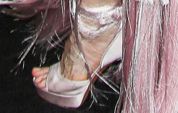 A close-up of Cate Blanchett’s satin platform Givenchy heels reveals their delicate ankle-tie detail beneath the gown’s cascading fringe