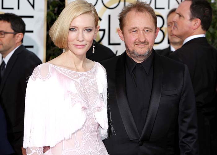 Cate Blanchett poses on the Golden Globes red carpet with husband Andrew Upton while highlighting the soft pastel tones of her custom Givenchy look