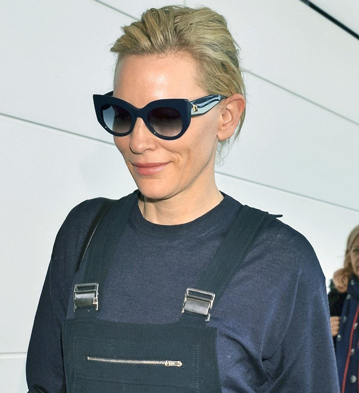 Cate Blanchett keeps her airport look understated with angular cat-eye sunglasses, a navy knit top, and tailored Chloé overalls at Narita International Airport in Japan