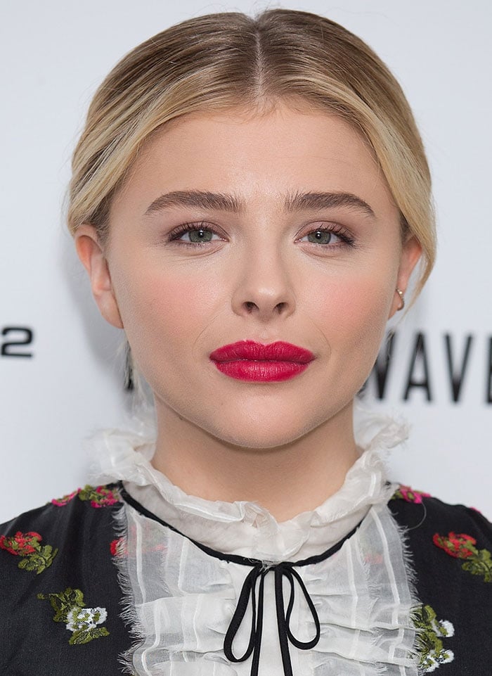 Chloë Grace Moretz pairs a bold red lip with a vintage-inspired floral Erdem dress featuring a delicate ruffled lace collar at The 5th Wave photocall in London