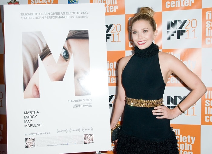 Elizabeth Olsen stuns in an elegant black halter-neck gown with a gold-embellished waist, perfectly paired with a sleek top knot and minimal accessories, as she attends the Martha Marcy May Marlene screening at the 49th New York Film Festival on October 11, 2011