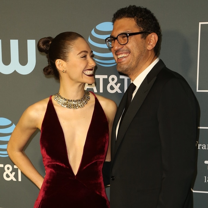Emmy Rossum beams beside husband Sam Esmail, their noticeable height difference adding to the couple’s striking red-carpet presence at the Critics’ Choice Awards