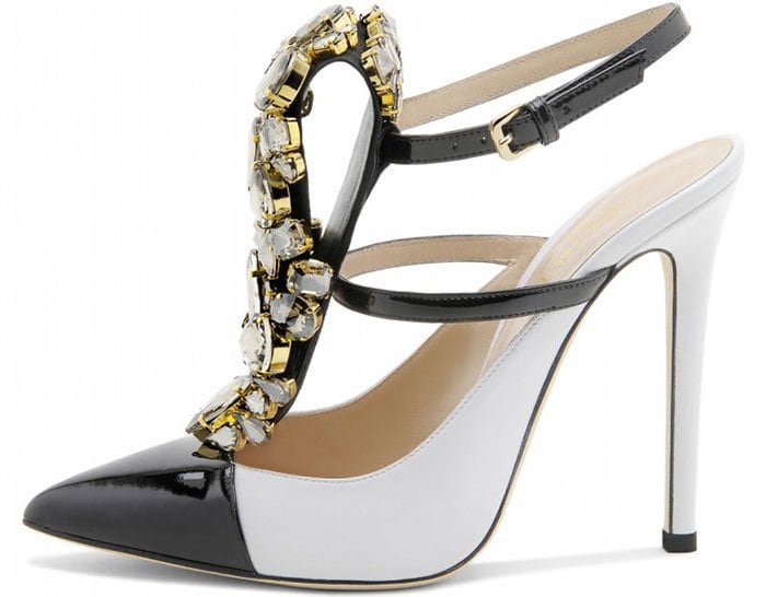 Gedebe “Mimi” pumps in white leather feature glossy black cap toes, slender ankle straps, and a dramatic cascade of faceted crystal embellishments