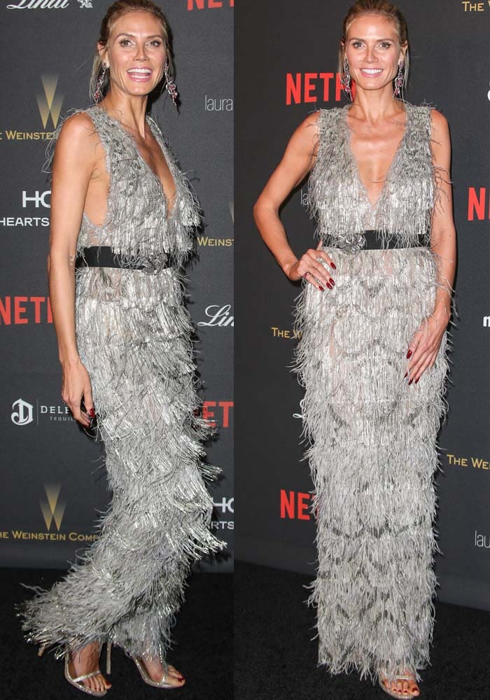 Heidi Klum commands the red carpet in a plunging silver-fringe Marchesa gown cinched at the waist, creating fluid movement with every step