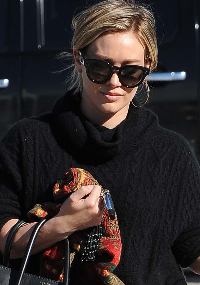 Hilary Duff wears her hair back during an outing with her son Luca Comrie