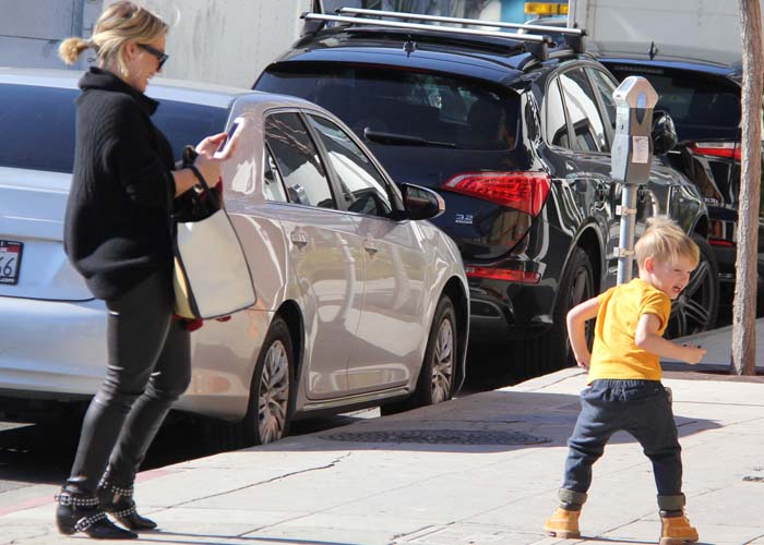 Keeping a watchful eye on Luca as he darted ahead on the sidewalk, Hilary Duff showcased the real-world practicality of her studded Marc by Marc Jacobs boots during a busy day out in Beverly Hills