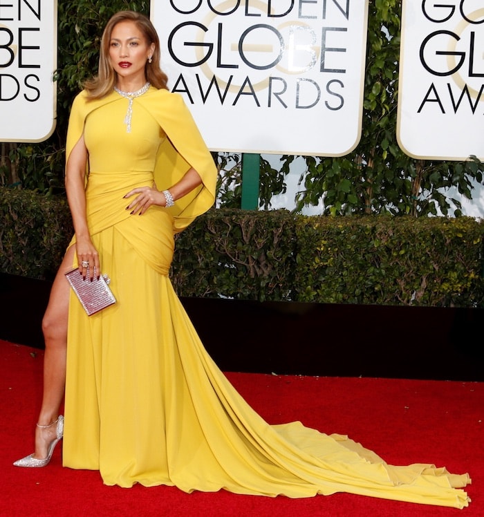 Jennifer Lopez shows the full sweep of her Giambattista Valli Haute Couture gown, its thigh-high slit revealing her crystal-embellished Jimmy Choo Lilyth pumps