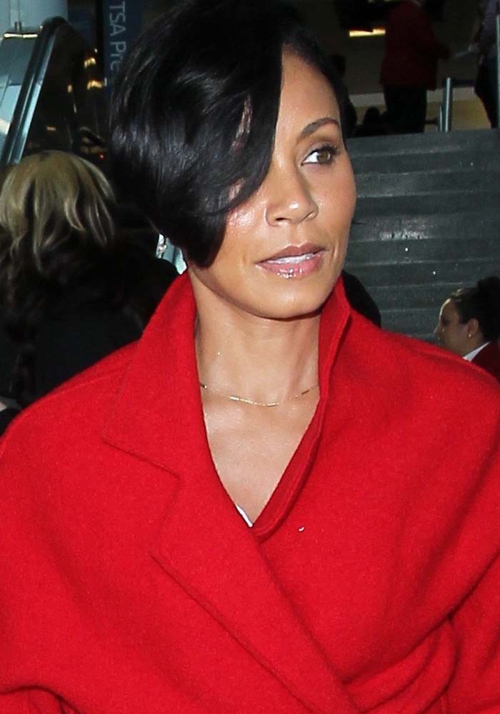 Jada Pinkett Smith wears her hair down as she arrives at Los Angeles International Airport