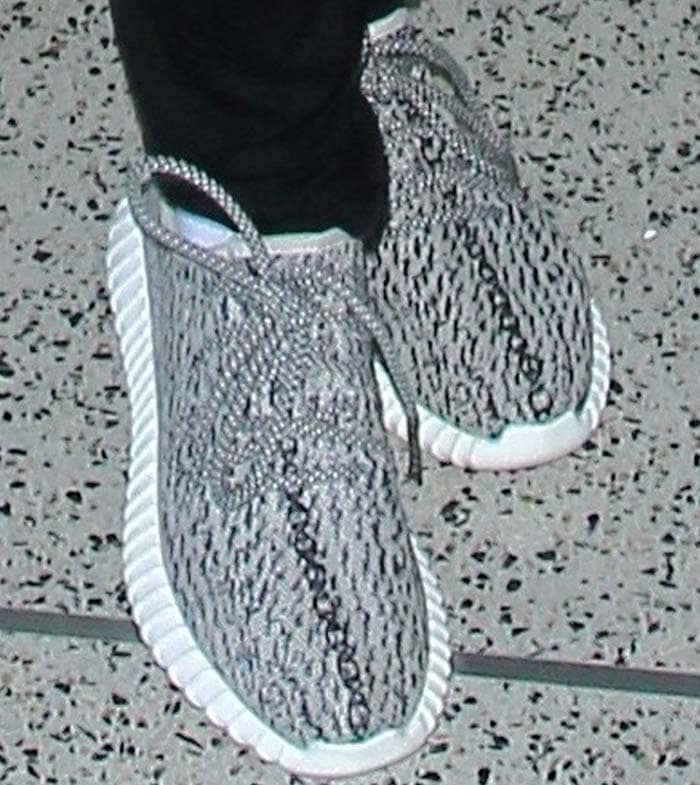 A close-up of Jada Pinkett Smith's Adidas Yeezy Boost 350 "Turtle Dove" sneakers highlights the signature gray-and-white Primeknit pattern and ribbed Boost sole that helped make the original 2015 release a sneaker icon