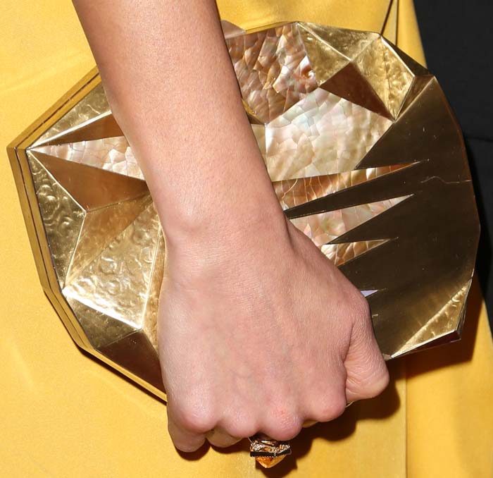 Jamie Chung adds an architectural touch to her Vivienne Westwood ensemble with a faceted mother-of-pearl Emm Kuo clutch featuring striking geometric panels