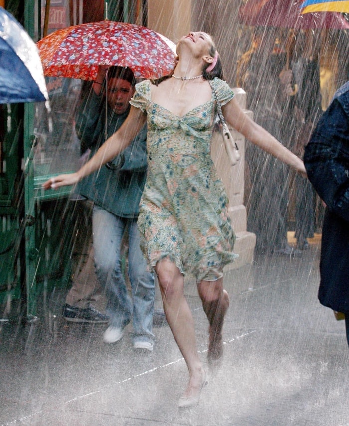 Jennifer Garner twirls barefoot in a pastel green floral dress and pearl choker, capturing Jenna Rink’s pure joy and emotional transformation in one of 13 Going on 30’s most iconic rain-soaked scenes