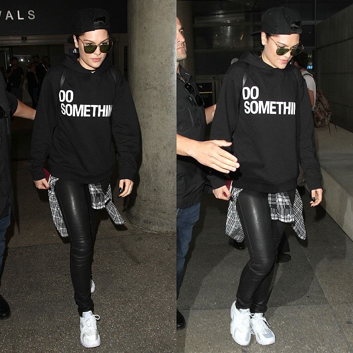 Jessie J leans into tomboy airport style, anchoring her statement sweatshirt and leather-look leggings with clean white sneakers while arriving at Los Angeles International Airport (LAX) on September 18, 2015