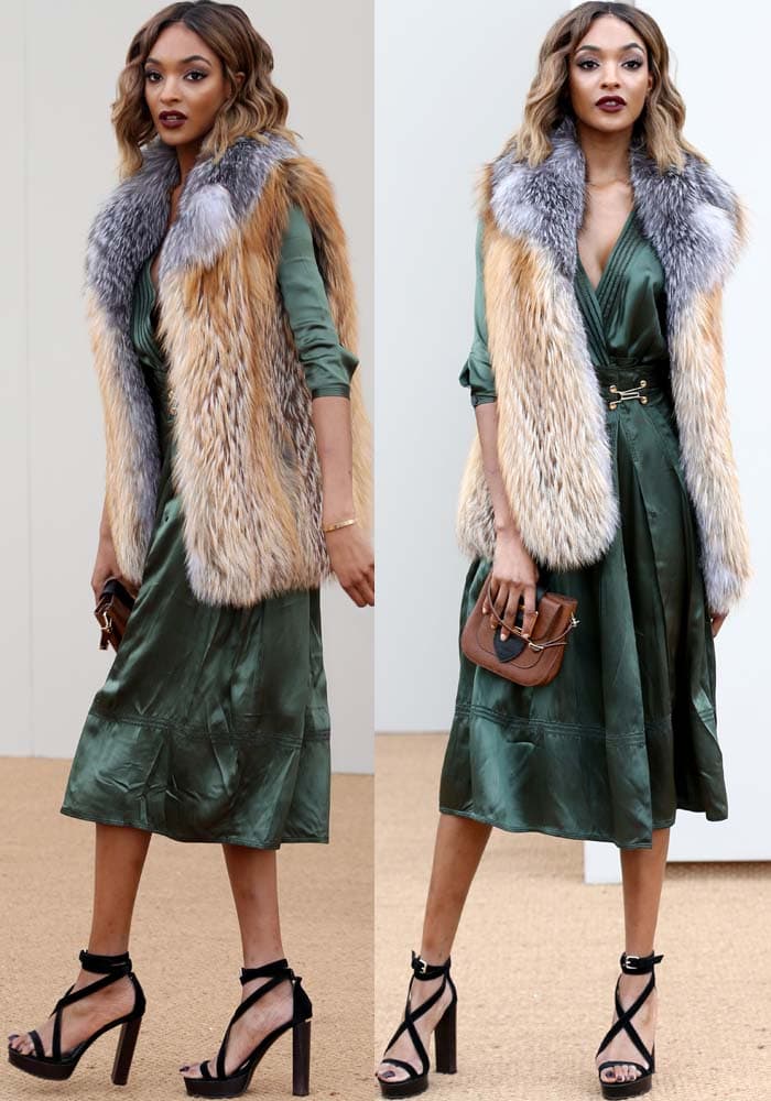 Jourdan Dunn flaunts her legs in an emerald green midi dress