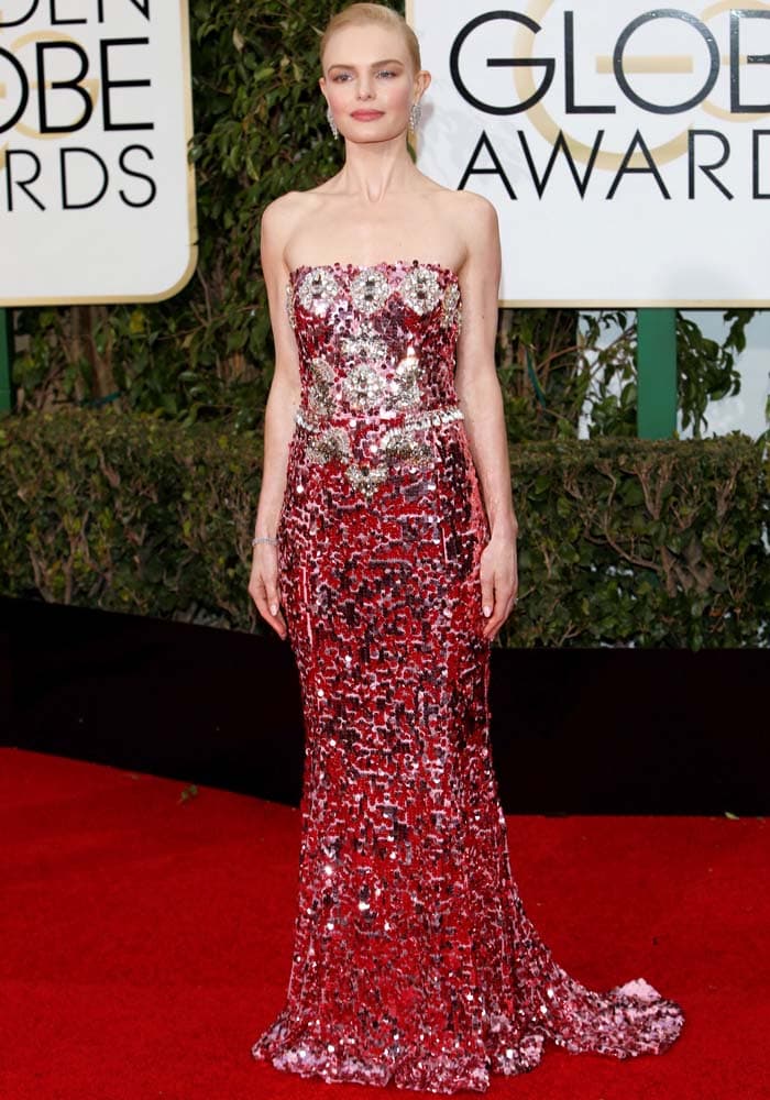 Kate Bosworth dazzles on the Golden Globes red carpet in a shimmering, strapless Dolce Gabbana gown adorned with intricate sequins and jewels, making a statement of elegance and glamour