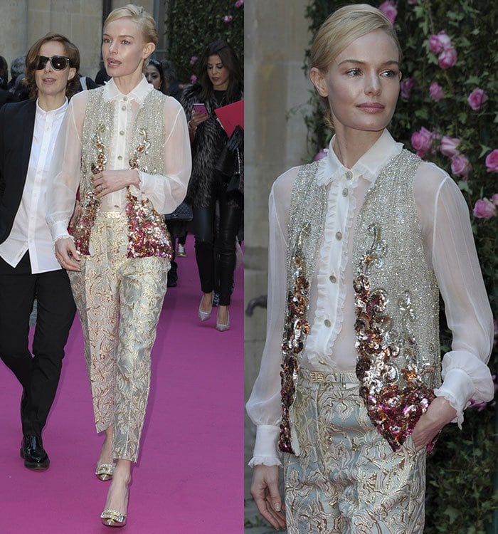 Kate Bosworth arrives at the Schiaparelli Haute Couture presentation in Paris wearing a sheer blouse, sequined waistcoat, and brocade trousers from the Fall 2015 couture collection